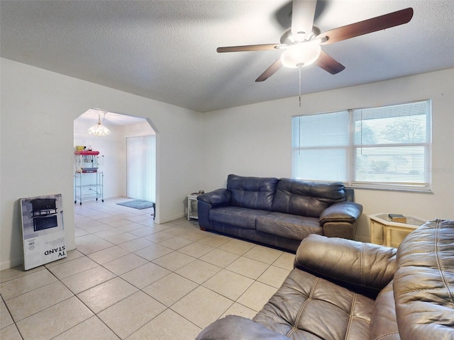 tiled living room featuring a textured ceiling and ceiling fan