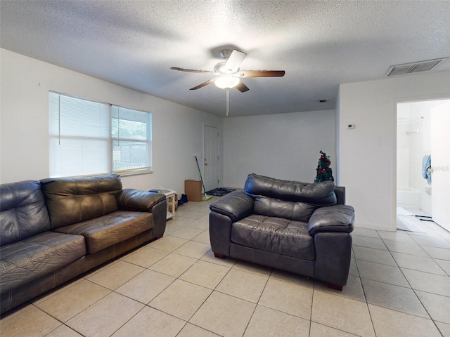 tiled living room featuring a textured ceiling and ceiling fan