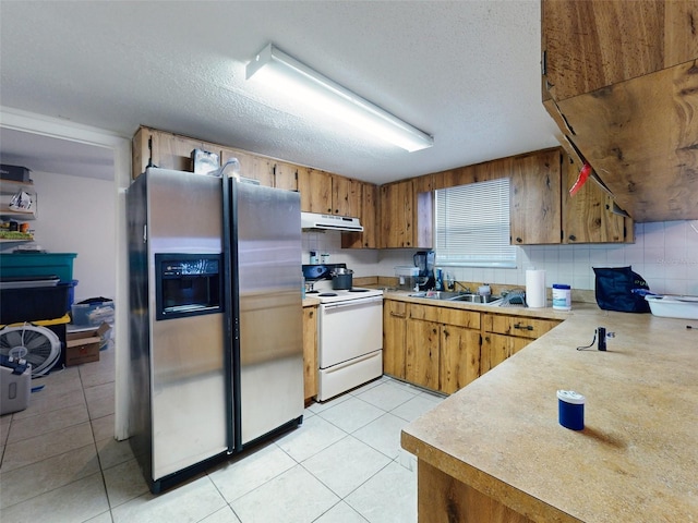 kitchen with electric stove, stainless steel fridge with ice dispenser, light tile floors, and a textured ceiling