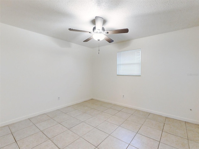 tiled spare room featuring a textured ceiling and ceiling fan