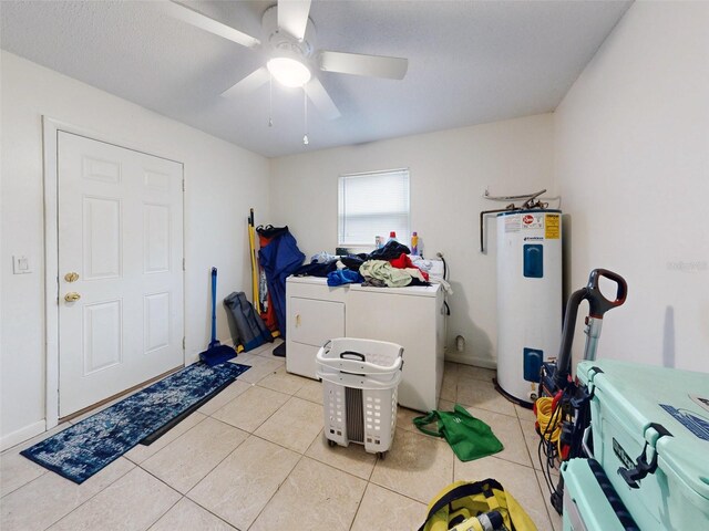 washroom with water heater, ceiling fan, washing machine and clothes dryer, and light tile flooring