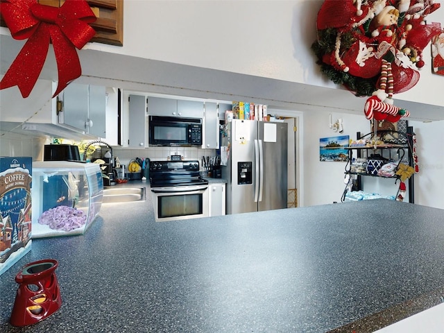 kitchen with sink, range with electric cooktop, tasteful backsplash, and stainless steel refrigerator with ice dispenser