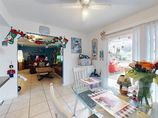 dining room with ceiling fan, light tile floors, and a wealth of natural light