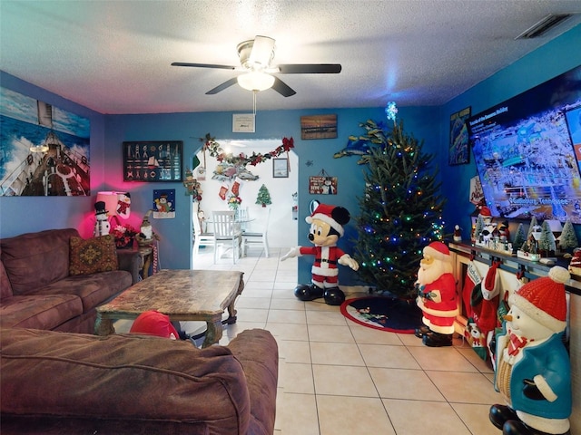 interior space with light tile floors, a textured ceiling, and ceiling fan