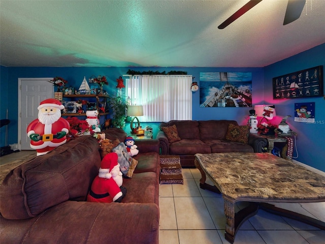 living room with a textured ceiling, light tile flooring, and ceiling fan