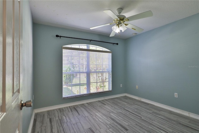 unfurnished room with ceiling fan and wood-type flooring