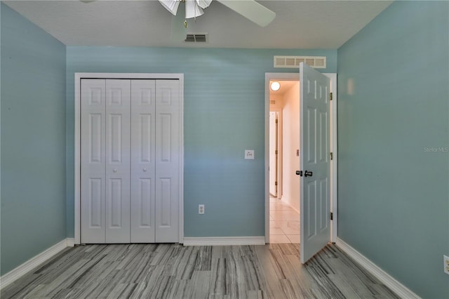 unfurnished bedroom with a closet, ceiling fan, and light tile floors