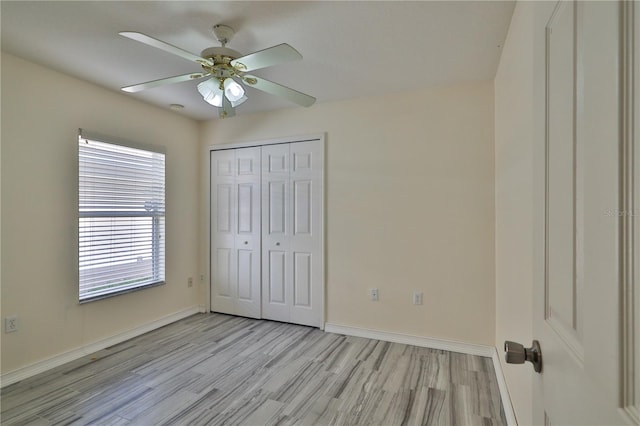 unfurnished bedroom featuring a closet, ceiling fan, and light wood-type flooring