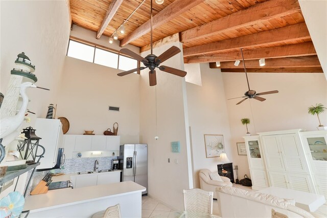 4875 S Atlantic Ave Unit E, New Smyrna Beach, FL 32169 - interior space featuring high vaulted ceiling, light tile flooring, wooden ceiling, and ceiling fan