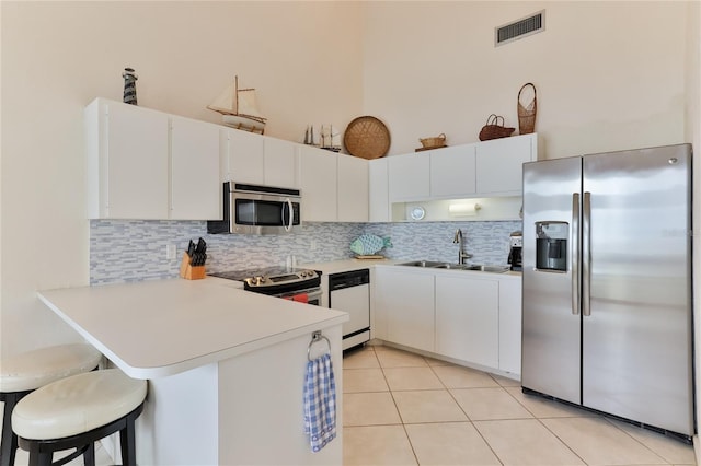 4875 S Atlantic Ave Unit E, New Smyrna Beach, FL 32169 - kitchen with tasteful backsplash, kitchen peninsula, appliances with stainless steel finishes, and sink