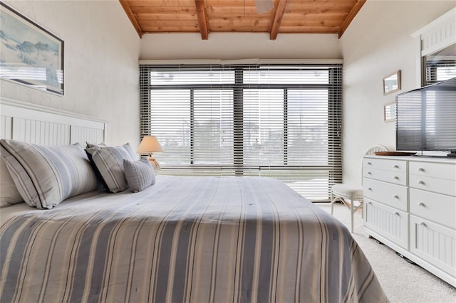 4875 S Atlantic Ave Unit E, New Smyrna Beach, FL 32169 - bedroom featuring lofted ceiling with beams, carpet floors, and wooden ceiling