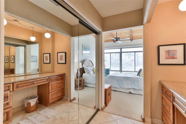4875 S Atlantic Ave Unit E, New Smyrna Beach, FL 32169 - bathroom featuring vanity, tile floors, and ceiling fan