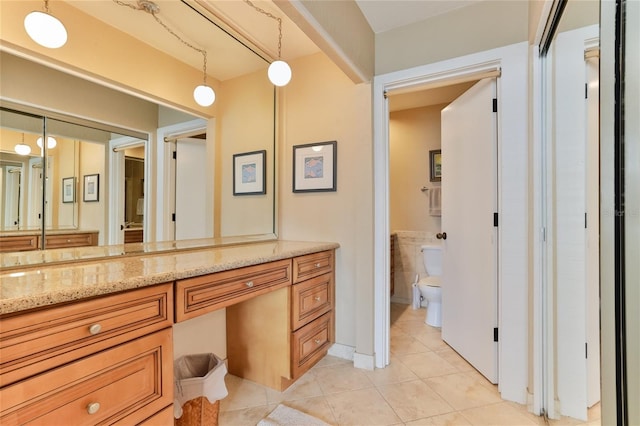 4875 S Atlantic Ave Unit E, New Smyrna Beach, FL 32169 - bathroom featuring toilet, tile floors, and vanity