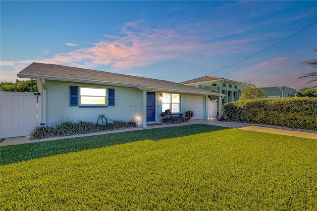 view of front of home with a lawn and a garage