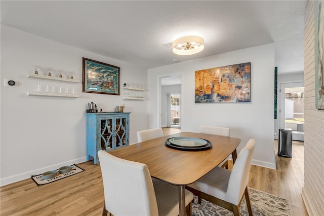 dining area with light hardwood / wood-style floors