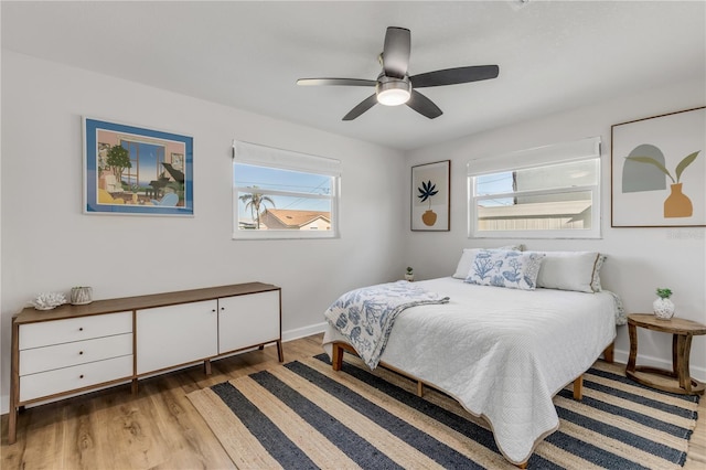 bedroom with ceiling fan and light hardwood / wood-style flooring