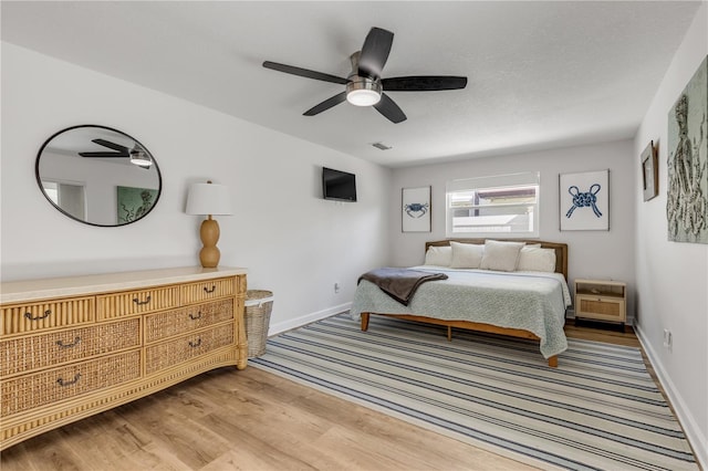 bedroom featuring light hardwood / wood-style floors and ceiling fan