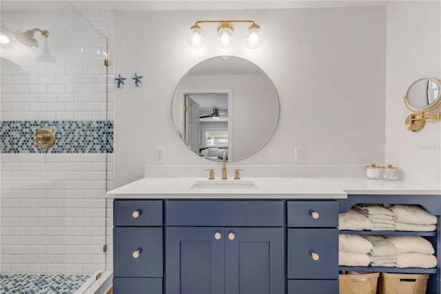 bathroom with vanity with extensive cabinet space and tiled shower