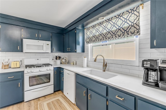 kitchen with tasteful backsplash, white appliances, and sink