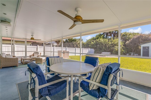 sunroom / solarium with plenty of natural light and ceiling fan