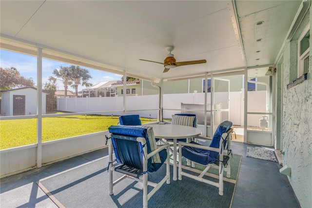 sunroom featuring ceiling fan