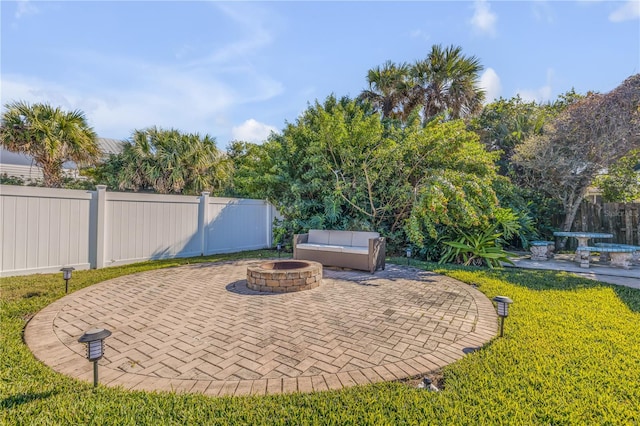 view of terrace with an outdoor fire pit