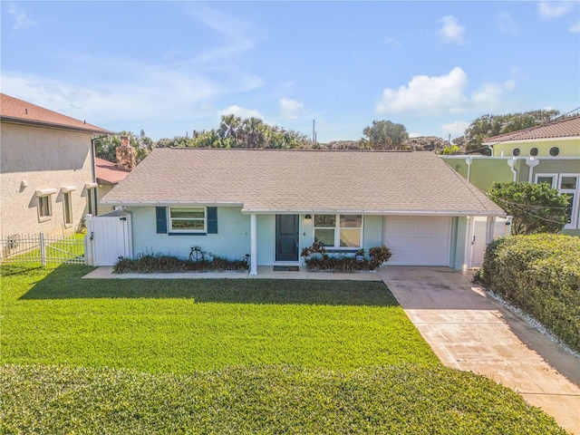 view of front of home featuring a front yard and a garage