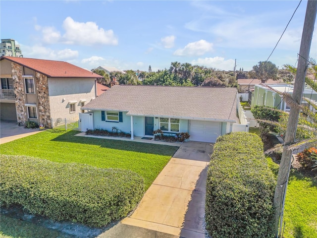 view of front of house with a front yard and a garage