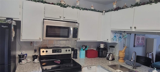 kitchen with appliances with stainless steel finishes and white cabinets