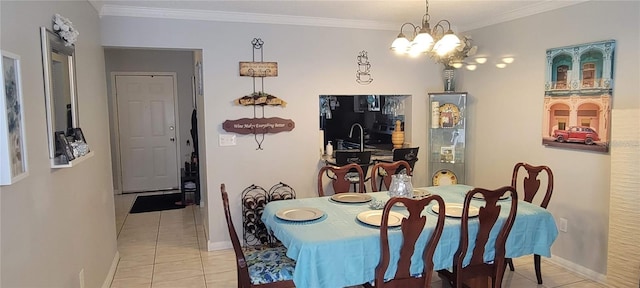 dining space featuring light tile floors, ornamental molding, and a chandelier