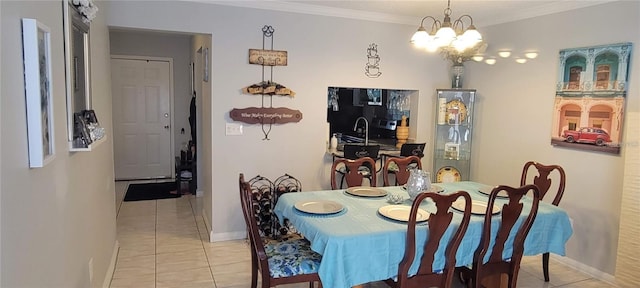 dining space featuring baseboards, an inviting chandelier, tile patterned flooring, and crown molding