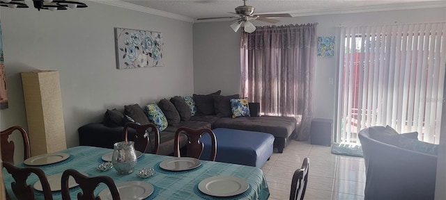 dining area featuring ornamental molding, ceiling fan, and light tile floors