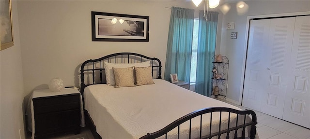 bedroom featuring light tile flooring and a closet