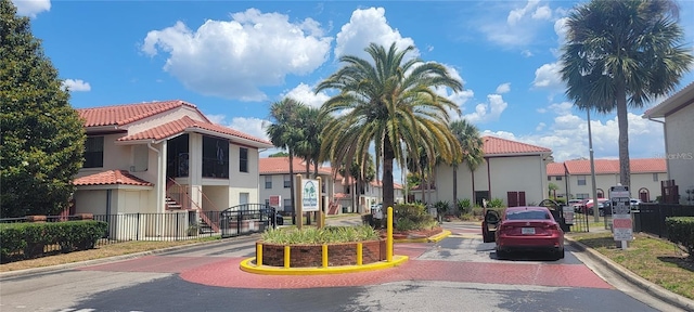 view of building exterior with a residential view and fence