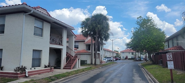 6294 River Run Pl Unit 193, Orlando, FL 32807 - view of asphalt road featuring curbs, a residential view, street lights, and stairs