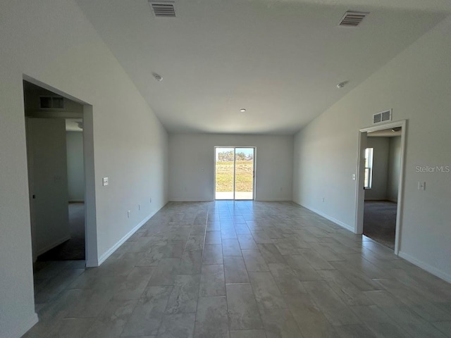 spare room with lofted ceiling