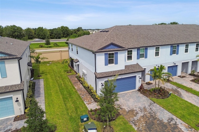 view of front of property featuring a garage and a front yard