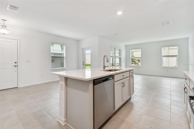 kitchen with a sink, visible vents, light countertops, and dishwasher