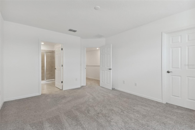 unfurnished bedroom featuring baseboards, a spacious closet, visible vents, and carpet flooring