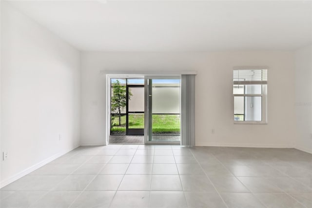 unfurnished room with baseboards and light tile patterned floors