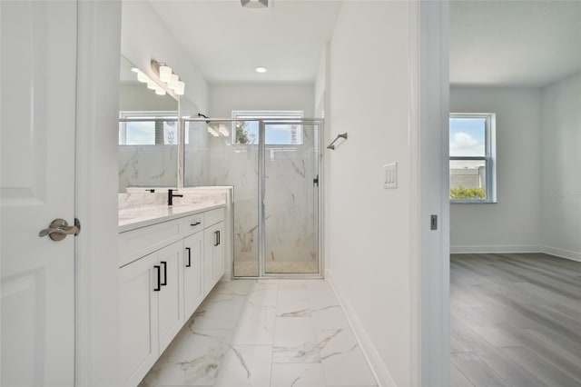 bathroom featuring vanity, wood-type flooring, and a shower with shower door