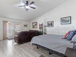 bedroom with ceiling fan, french doors, vaulted ceiling, and light wood-type flooring