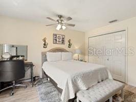 bedroom featuring a closet, ceiling fan, and hardwood / wood-style floors