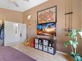 bedroom with light hardwood / wood-style flooring and ceiling fan