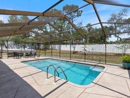 view of swimming pool with a lanai and a patio