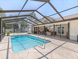 view of pool featuring a patio area and a lanai