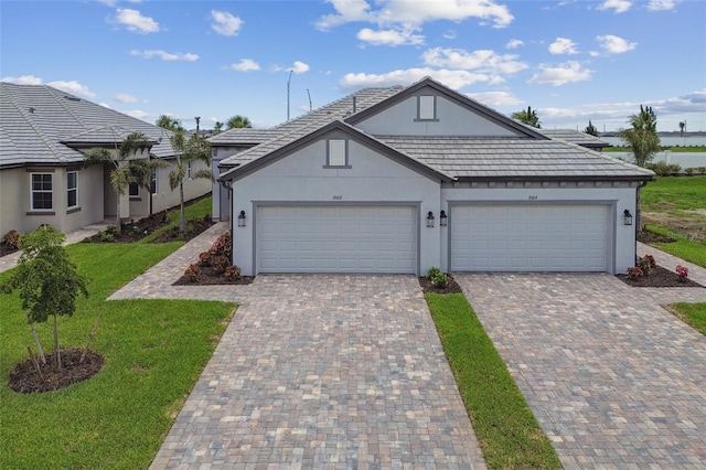 view of front of property with a front yard and a garage