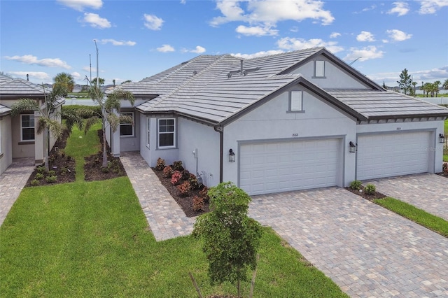 ranch-style house featuring a garage and a front lawn