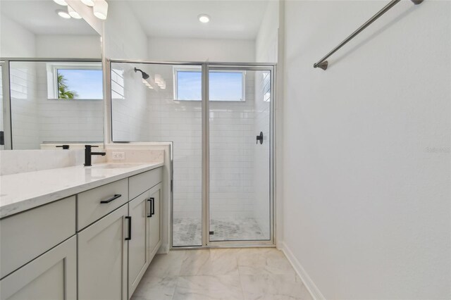 bathroom with tile patterned floors, vanity, and walk in shower