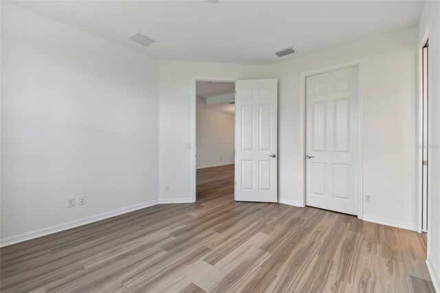 unfurnished bedroom featuring hardwood / wood-style floors